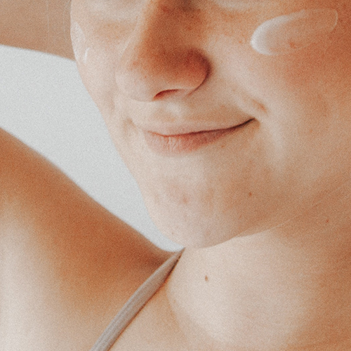 Close-up of a smiling person representing a comfortable and painless procedure for enhancing skin smoothness.