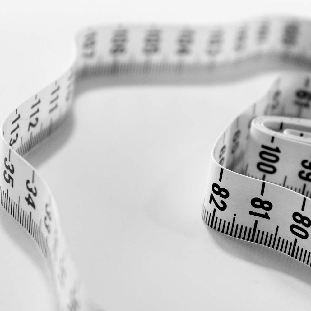 Measuring tape representing body contouring and weight management in dermatology
