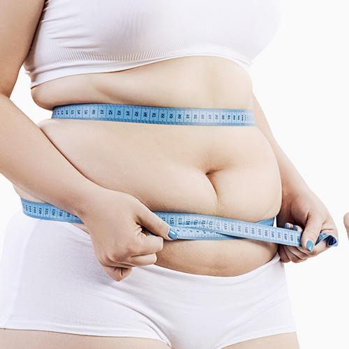 Fat reduction and body tightening - Woman measuring her waist
