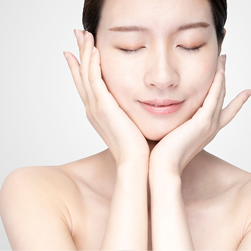 Woman gently holding her cheeks, indicating targeted slimming for specific face areas