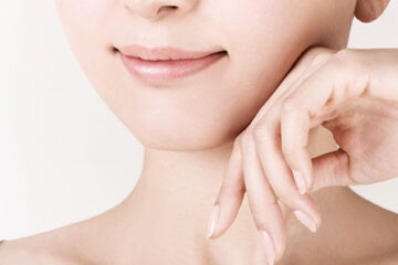 Close up of a woman's face and hand with smooth, youthful skin highlighting long-lasting results in skin care.