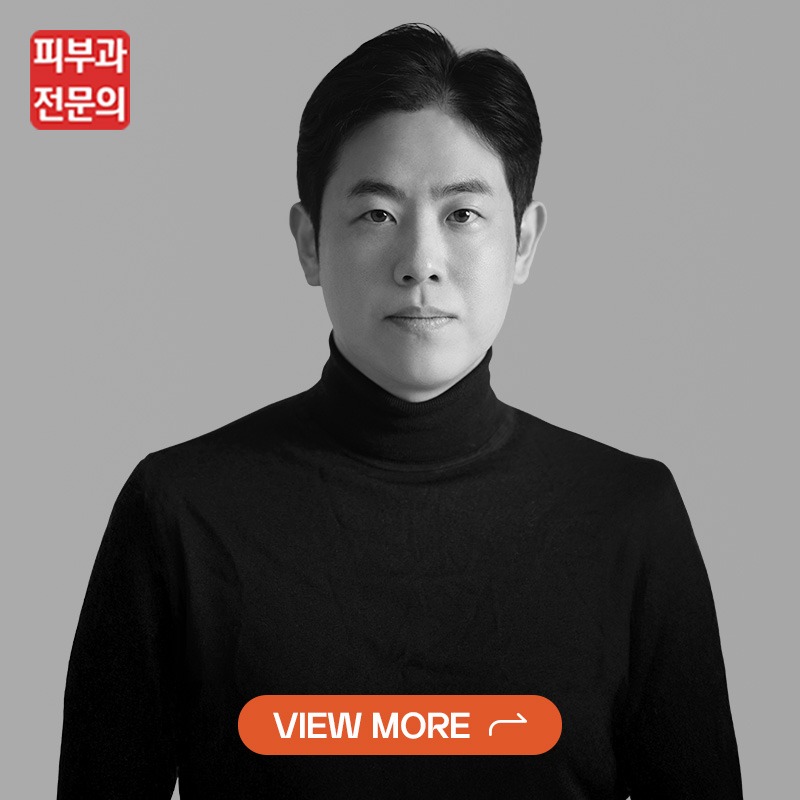 Portrait of a person in a black turtleneck against a gray background, with a red Korean logo in the top-left and an orange 'VIEW MORE' button at the bottom.