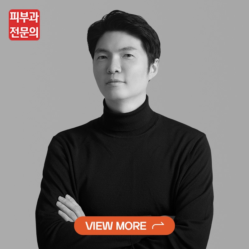 Portrait of a man in a black turtleneck against a gray background, with a red logo in the top-left and an orange 'VIEW MORE' button at the bottom center.