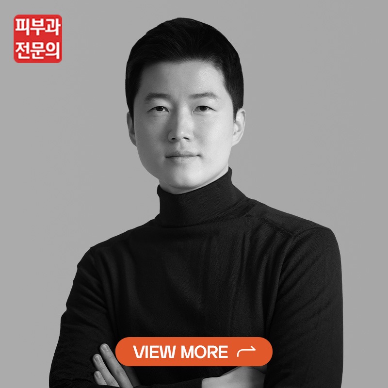 Professional black-and-white portrait of a man in a turtleneck, with a red brand logo in the top-left and an orange 'VIEW MORE' button overlapping the lower chest area.