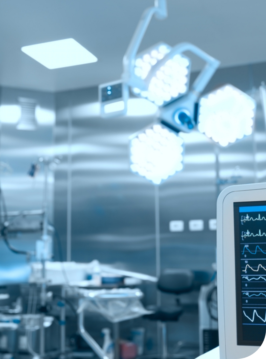 Modern surgical room with advanced medical equipment and monitors showing vital signs