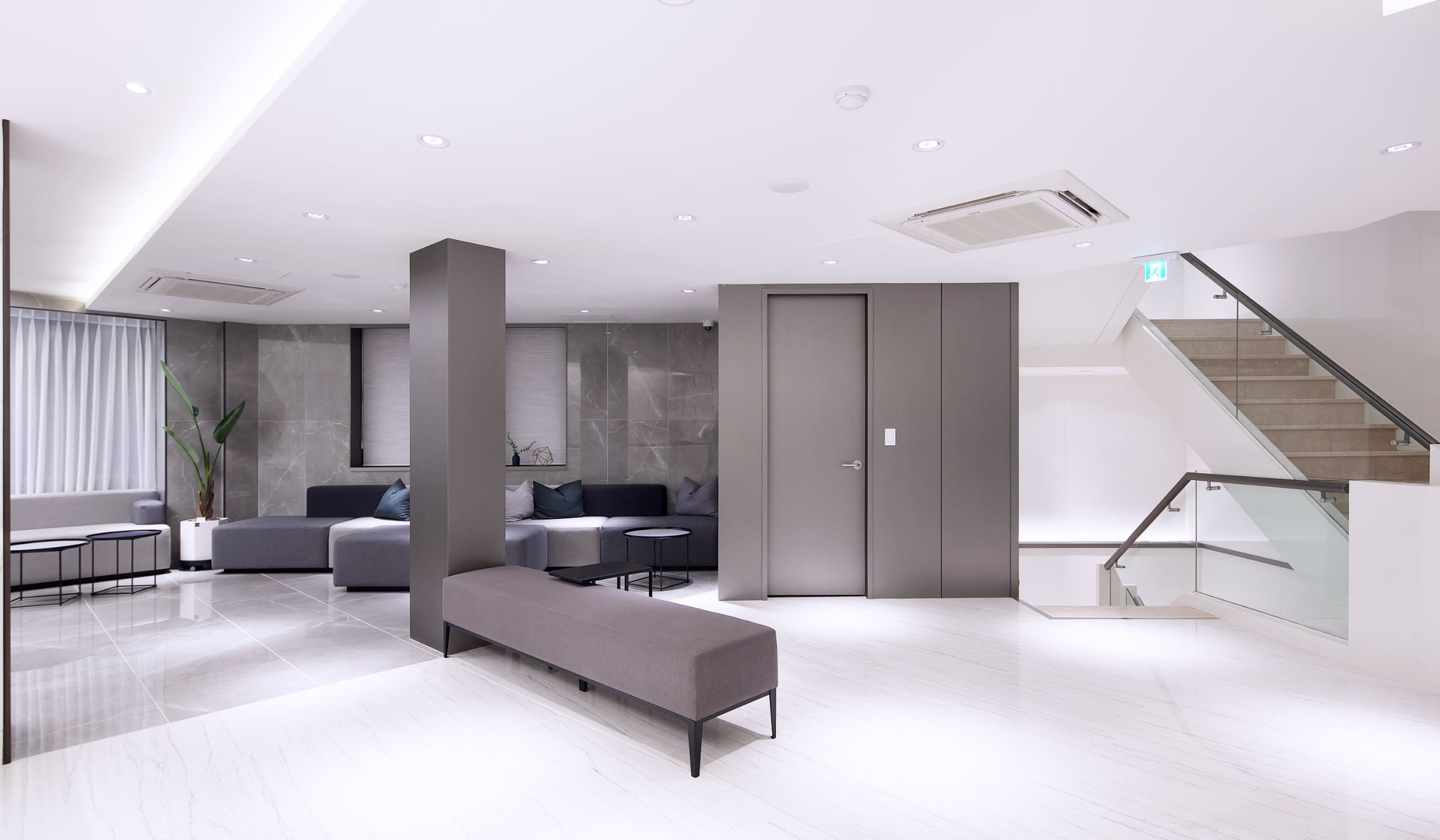 Spacious and elegant waiting area in a plastic surgery clinic featuring contemporary furniture and soft lighting.